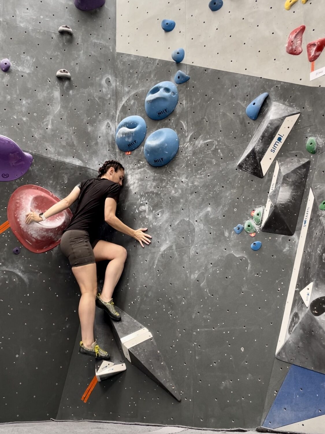 Woman bouldering indoors